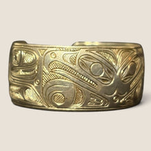 Load image into Gallery viewer, Ziebarth's Antiques gold-tone metal cuff bracelet featuring intricate Northwest Coast Indigenous formline engravings.