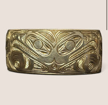 Load image into Gallery viewer, Ziebarth's Antiques gold-tone metal cuff bracelet featuring intricate Northwest Coast Indigenous formline engravings.