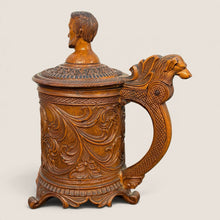 Load image into Gallery viewer, Ziebarth's Antiques hand-carved wooden beer stein with intricate floral relief, dog-head handle, and bust finial lid.