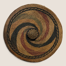 Load image into Gallery viewer, Ziebarth's Antiques handwoven lidded basket with a spiral pattern in earthy brown, ochre, black, and rust tones.