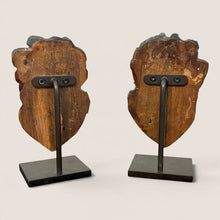 Load image into Gallery viewer, Back view of Ziebarth's Antiques hand-carved wooden cherub head sculptures mounted on black metal stands.