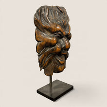 Load image into Gallery viewer, Ziebarth's Antiques hand-carved wooden Green Man mask sculpture with leaf details on a minimalist black metal stand.